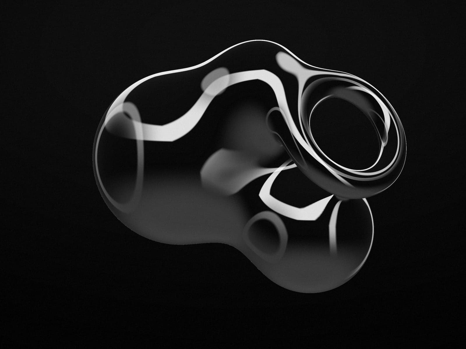 A sculptural dark chrome form reflecting studio light